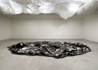 Drift art installation. Black cloth on floor with arranged parachute above it. Drift by Brigitte D'Annible